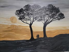 Couple standing between two trees on a landscape