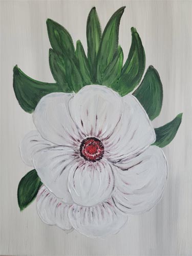 White flower with red center and green leaves