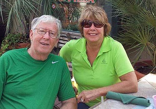 Wil and her husband Bob enjoying a meal at an outdoor cafe.